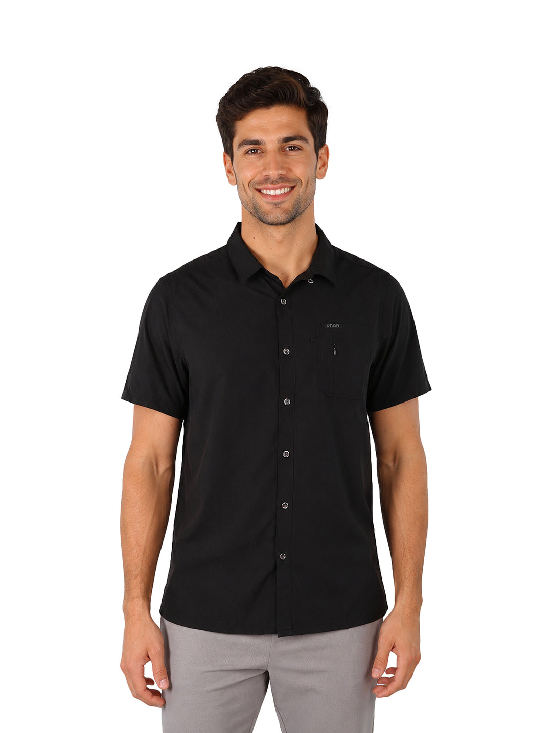 Hombre vistiendo una camisa outdoor de manga corta color negro, corte regular fit con botones y bolsillo frontal.