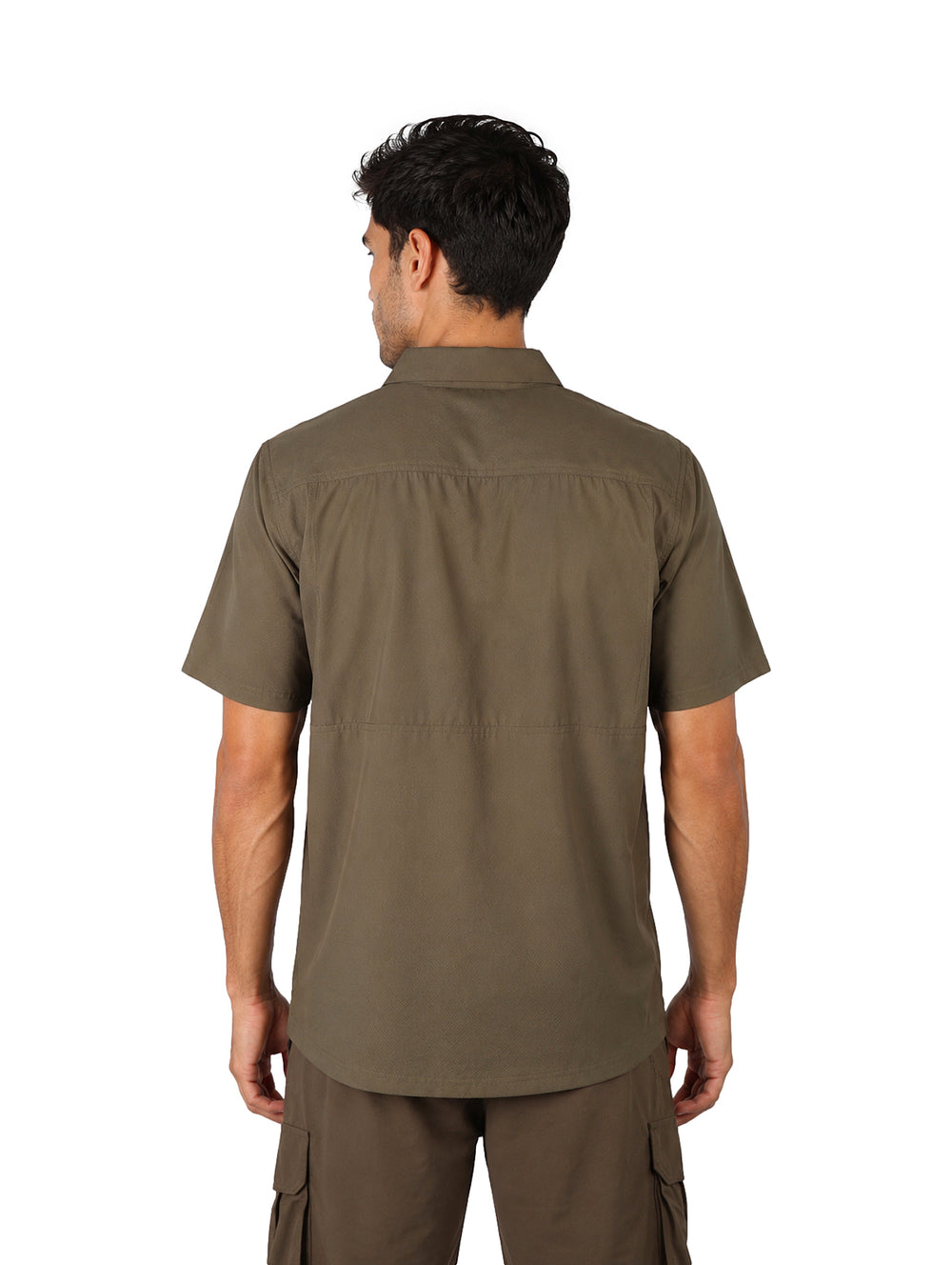 Hombre vistiendo una camisa outdoor de manga corta en color verde militar con un bolsillo en el pecho.
