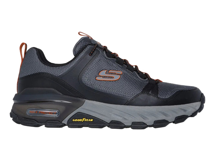Tenis Skechers para hombre en color negro y gris, diseño robusto para actividades al aire libre con suela Goodyear.