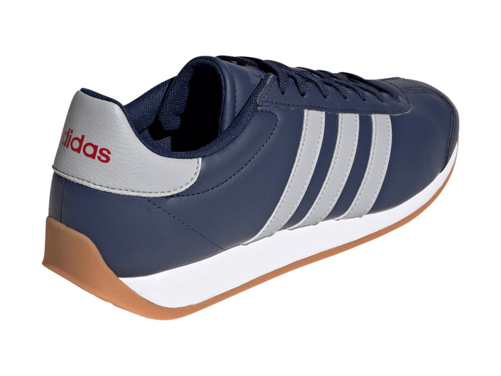 Tenis Adidas Runvista azul marino con franjas grises, entresuela blanca y suela de goma color café.