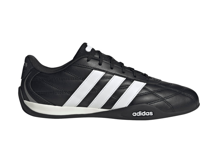 Zapato deportivo Adidas Adipista color negro con tres franjas blancas laterales y suela blanca y negra.