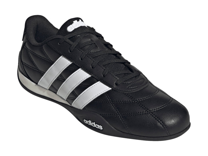 Zapato deportivo Adidas Adipista color negro con tres franjas blancas laterales y suela blanca y negra.