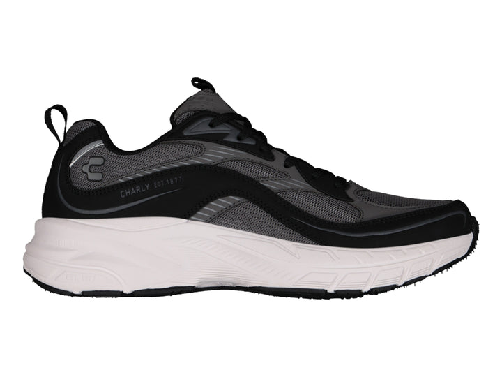 Tenis deportivos Charly color negro con suela blanca ancha y detalles en gris.
