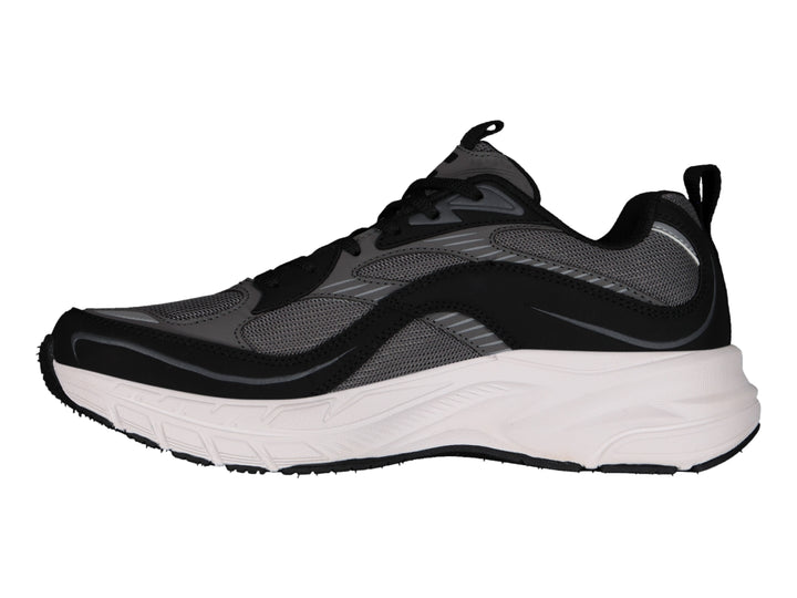 Tenis deportivos Charly color negro con suela blanca ancha y detalles en gris.