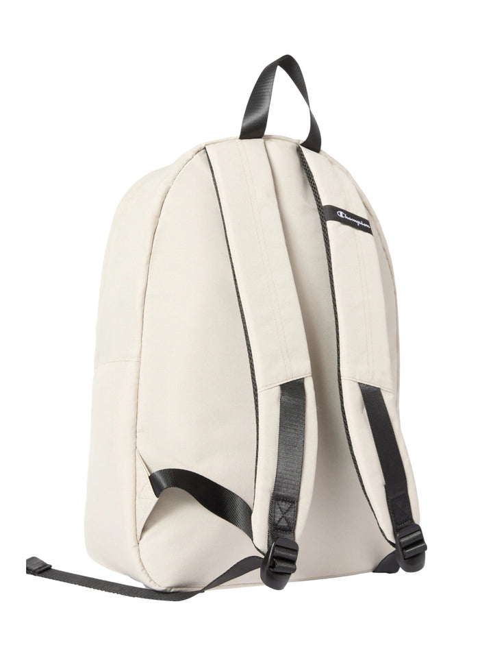 Mochila escolar Champion color beige con detalles en negro y logotipo frontal.