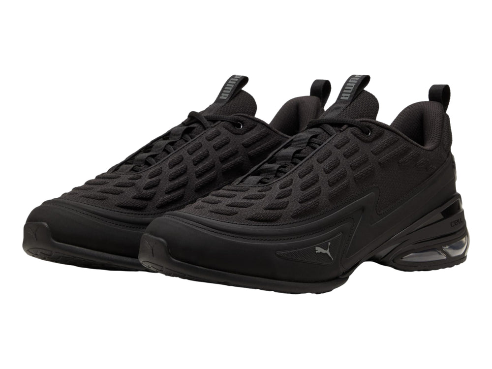 Tenis PUMA color negro con detalles en gris oscuro y cámara de aire visible en el talón.