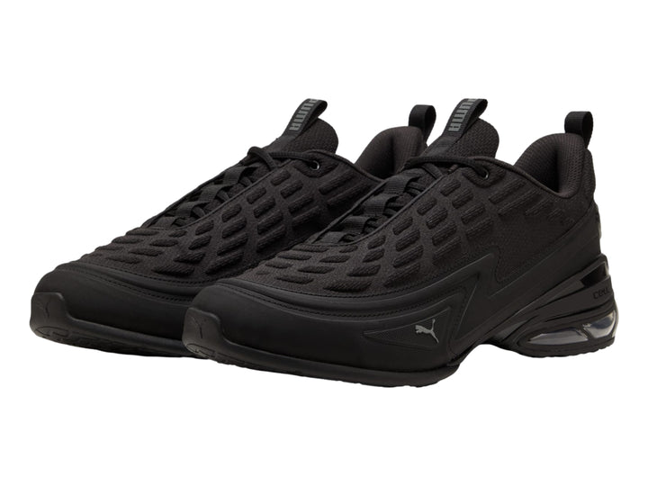 Tenis PUMA color negro con detalles en gris oscuro y cámara de aire visible en el talón.