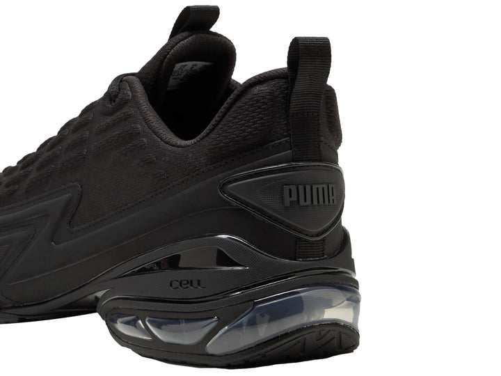 Tenis PUMA color negro con detalles en gris oscuro y cámara de aire visible en el talón.