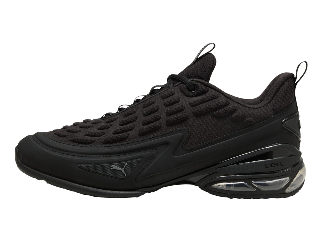 Tenis PUMA color negro con detalles en gris oscuro y cámara de aire visible en el talón.