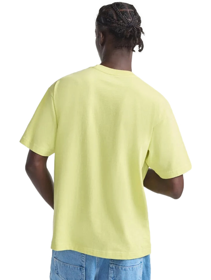 Hombre vistiendo una camiseta de manga corta color amarillo canario con logo de Vans en el pecho.