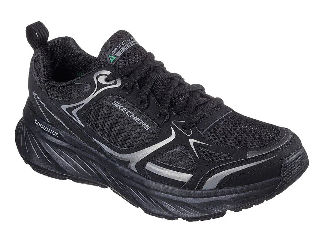 Tenis deportivos Skechers color negro con detalles en plata y suela gruesa.
