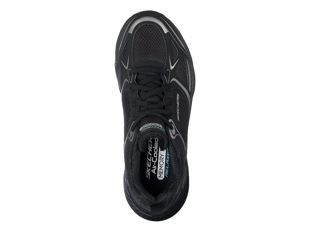 Tenis deportivos Skechers color negro con detalles en plata y suela gruesa.