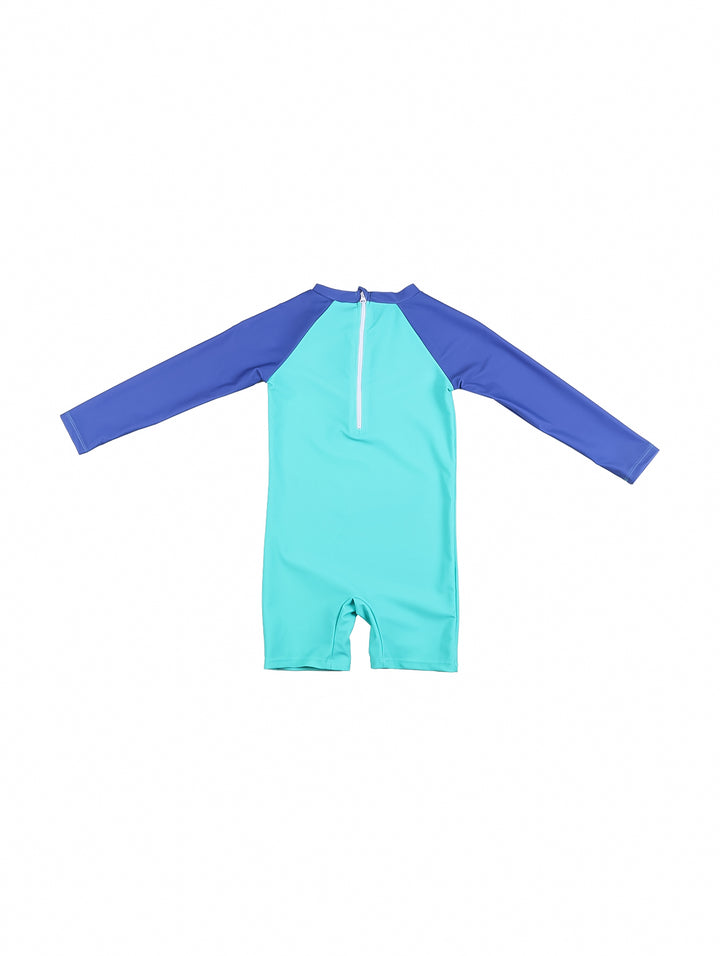 Traje de baño de una pieza para niño, color turquesa y azul, con dibujo de dinosaurio sobre una patineta.