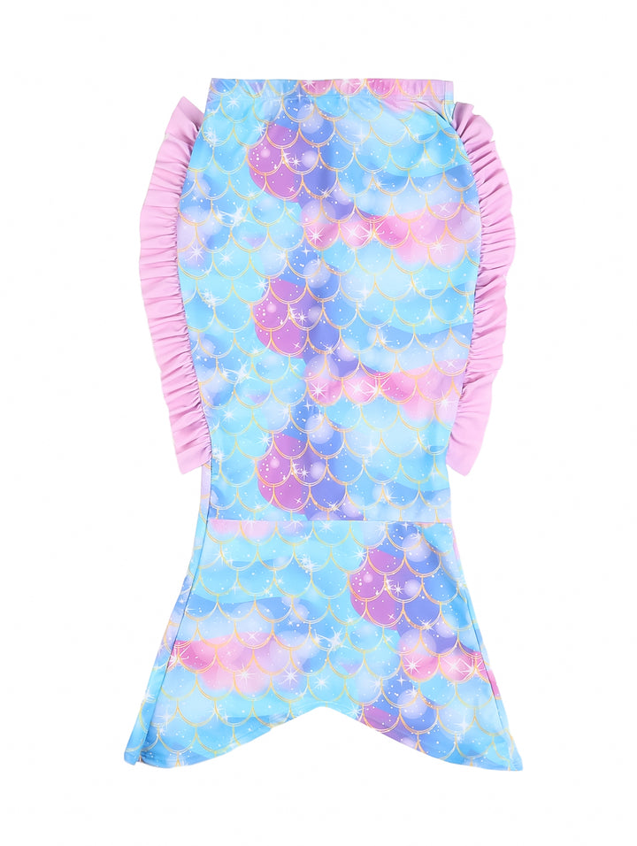 Traje de baño enterizo para niña con estampado de escamas de sirena en azul y rosa y un moño rosa en el hombro.
