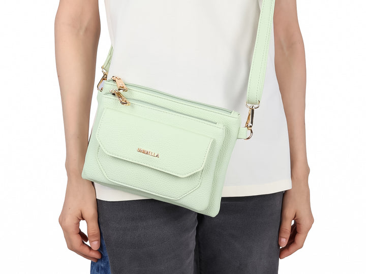 Bolso pequeño de color verde menta marca UNIBELLA con múltiples compartimentos y cierres dorados.