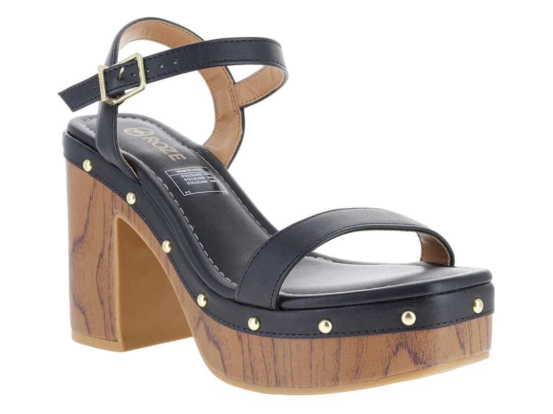 Sandalias negras de plataforma con tacón efecto madera y detalles metálicos dorados.