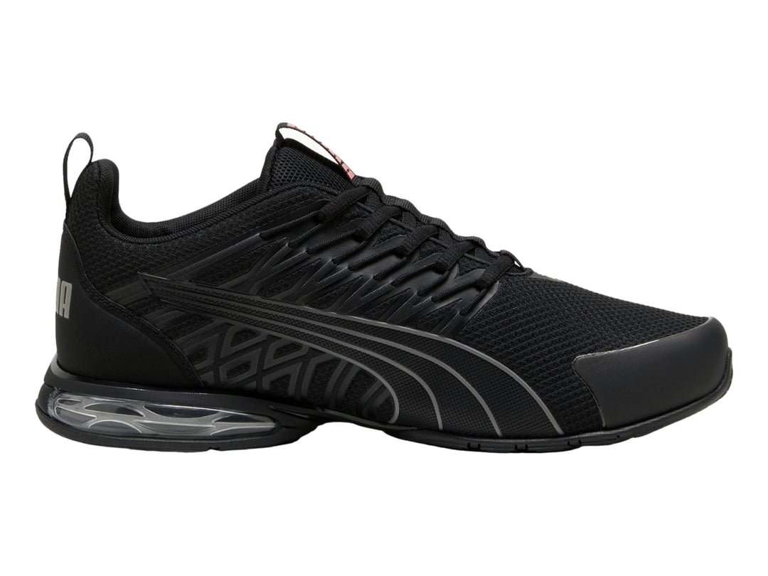 Tenis deportivos PUMA en color negro con detalles en gris y suela con cámara de aire visible.