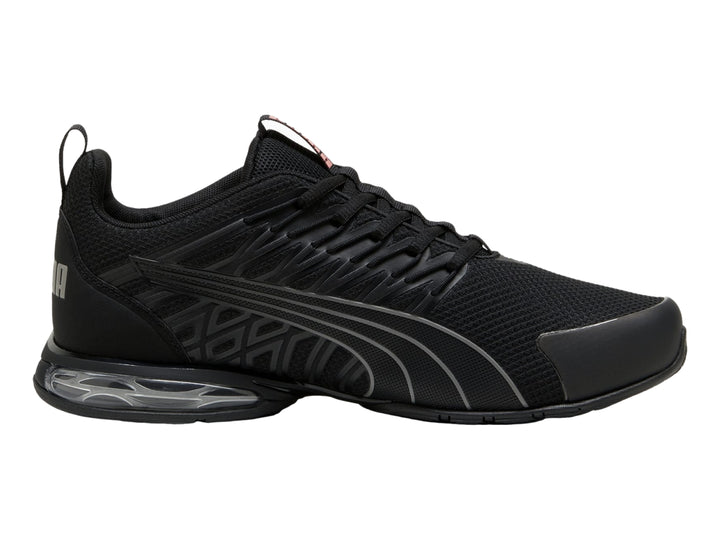 Tenis deportivos PUMA en color negro con detalles en gris y suela con cámara de aire visible.
