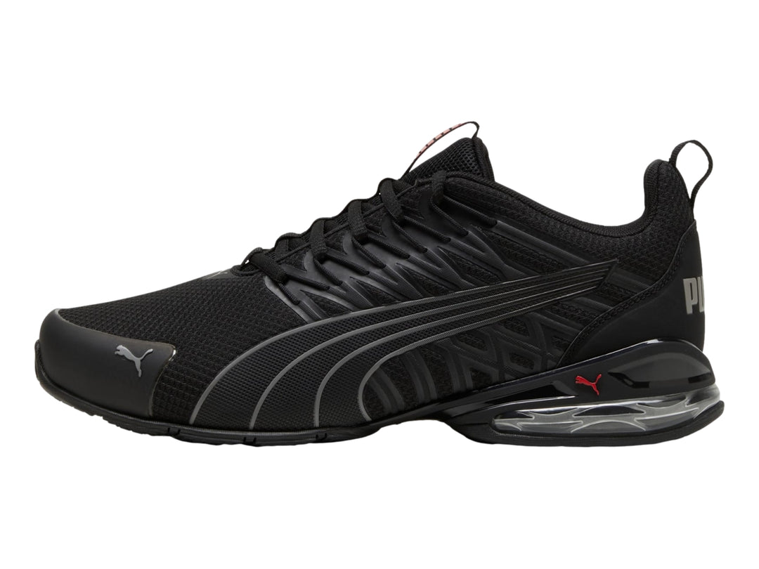Tenis deportivos PUMA en color negro con detalles en gris y suela con cámara de aire visible.