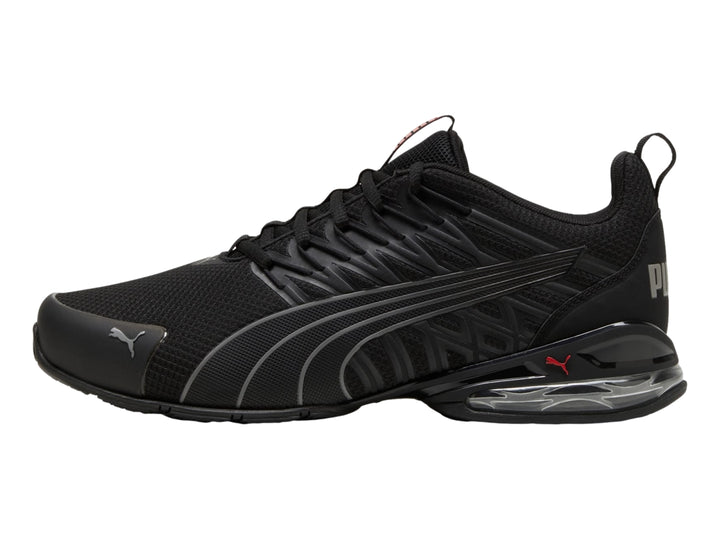 Tenis deportivos PUMA en color negro con detalles en gris y suela con cámara de aire visible.