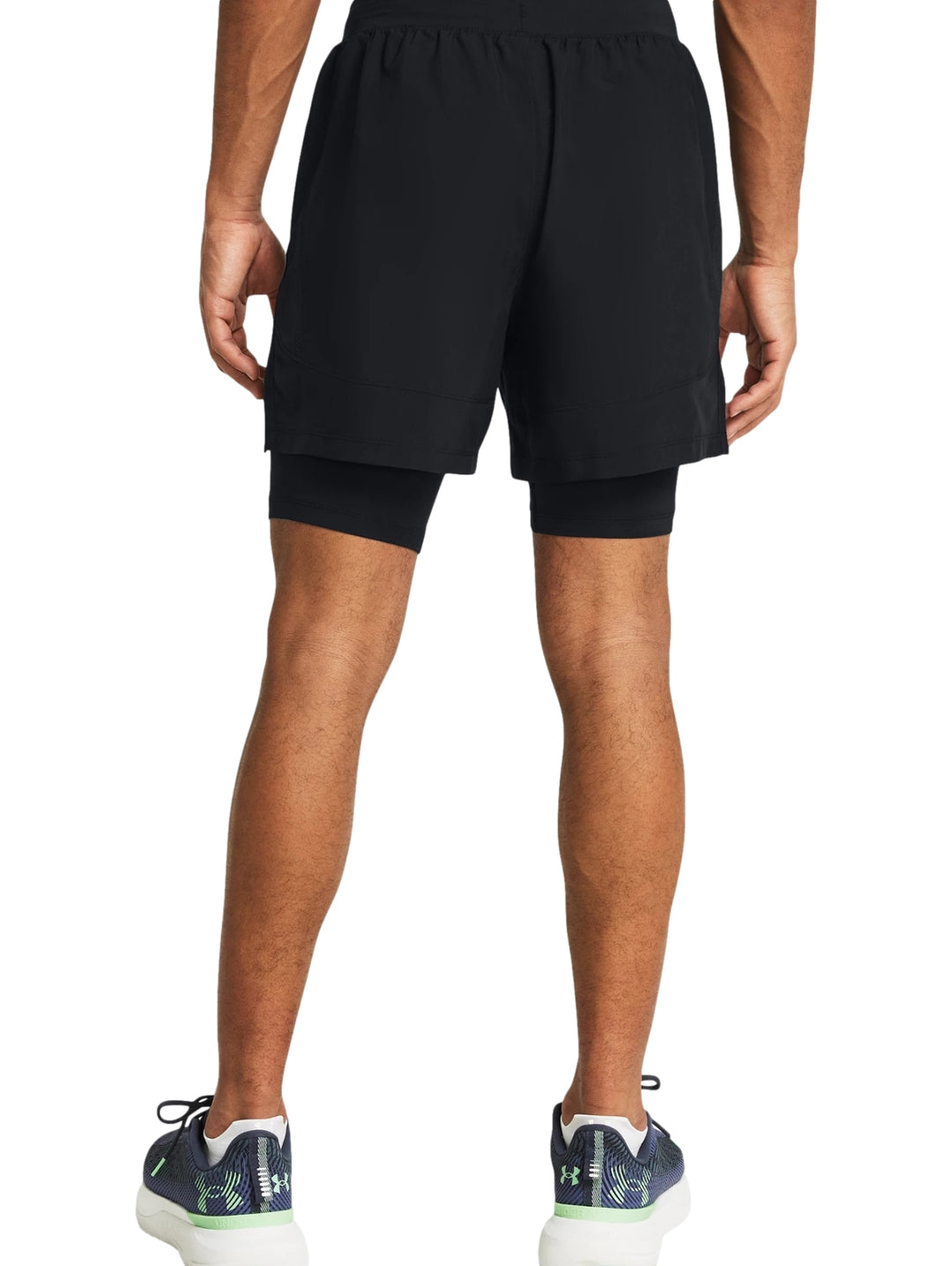 Hombre vistiendo shorts deportivos 2 en 1 de color negro marca Under Armour.