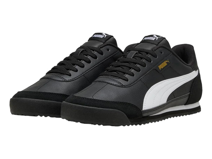 Tenis PUMA Turino II OG color negro con franja blanca lateral y detalles dorados.
