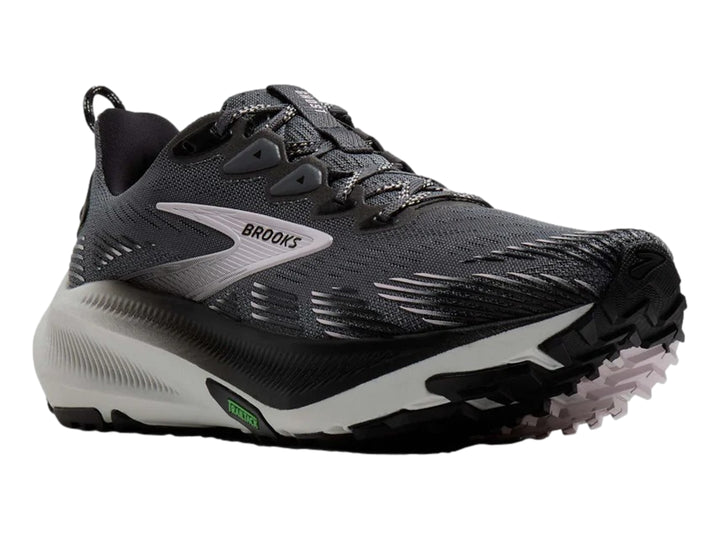 Tenis de trail running Brooks en color gris oscuro con suela blanca y detalles en negro.