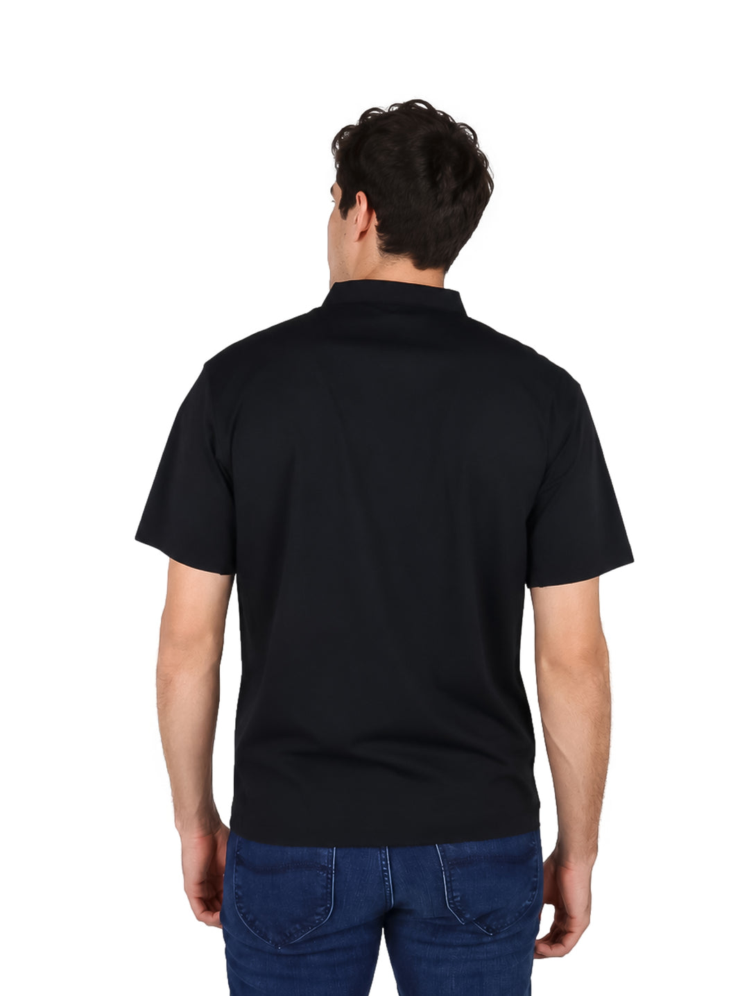 Hombre vistiendo una playera polo color negro de manga corta y pantalones vaqueros azules.