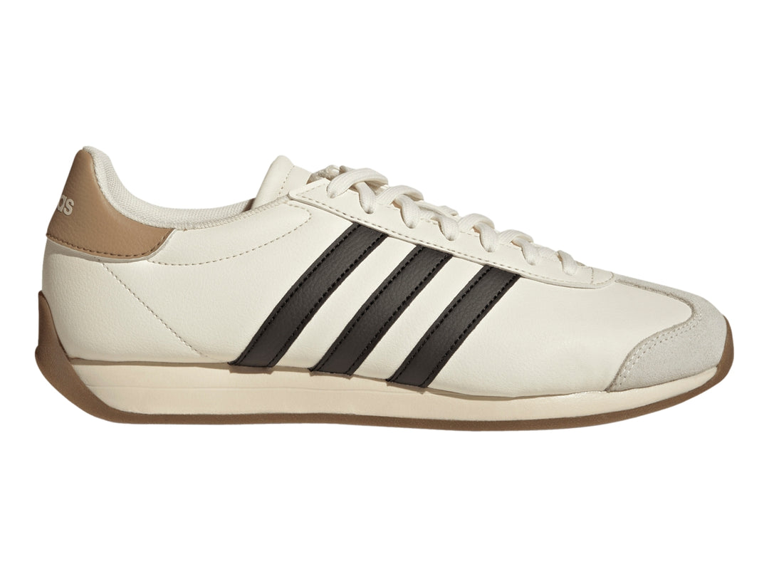 Tenis Adidas color blanco crema con tres franjas negras laterales y suela color café.