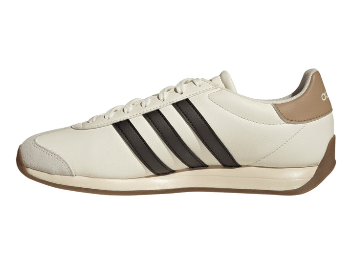 Tenis Adidas color blanco crema con tres franjas negras laterales y suela color café.