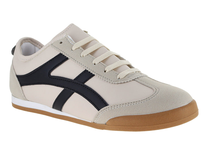 Tenis Andrax color latte con franjas negras y suela de goma marrón.