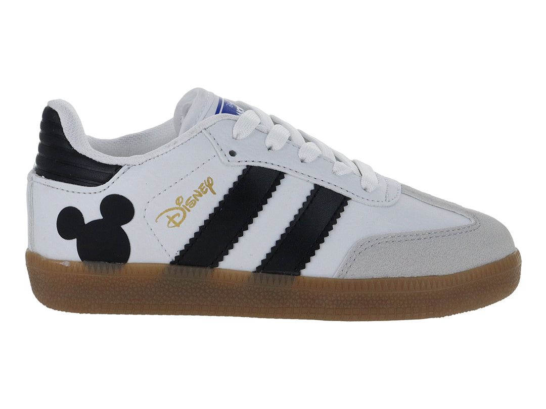 Tenis blancos para niño con franjas negras, suela color café y diseño de Mickey Mouse en el talón.