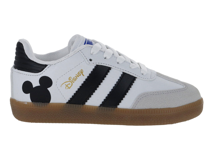 Tenis blancos para niño con franjas negras, suela color café y diseño de Mickey Mouse en el talón.
