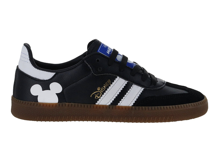 Tenis negros DTX con suela café, rayas blancas laterales y silueta de Mickey Mouse en el talón.