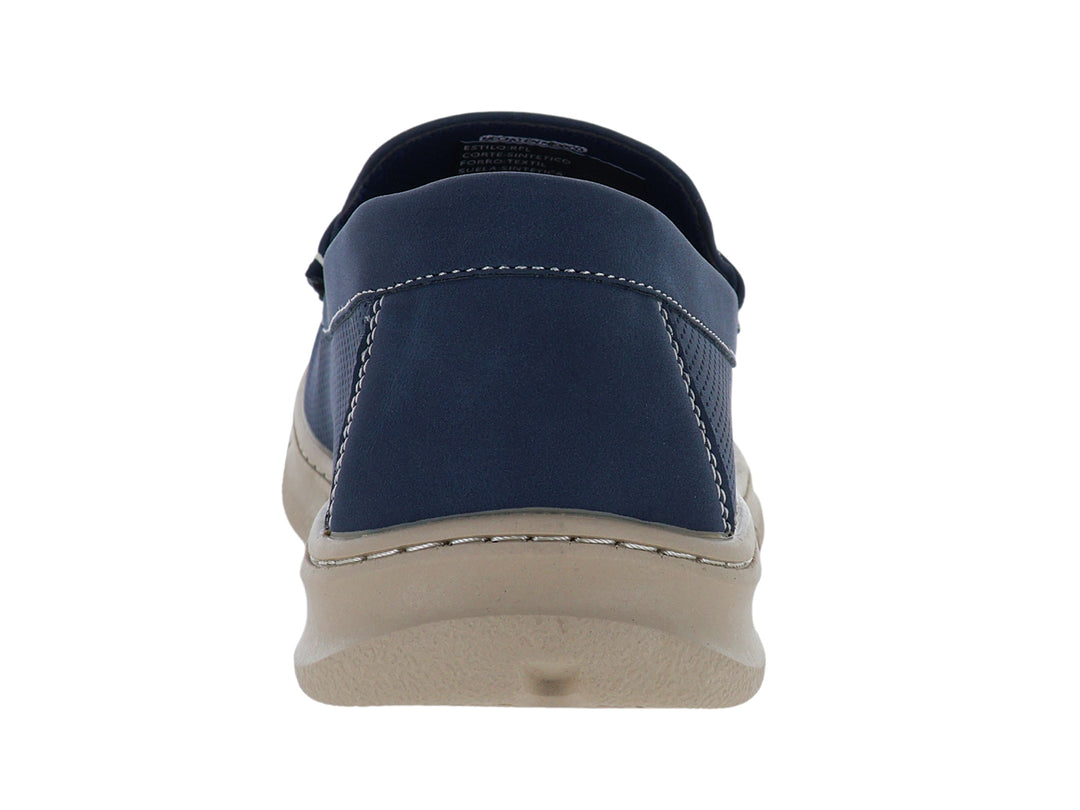 Zapato tipo mocasín color azul con suela beige y detalles perforados.