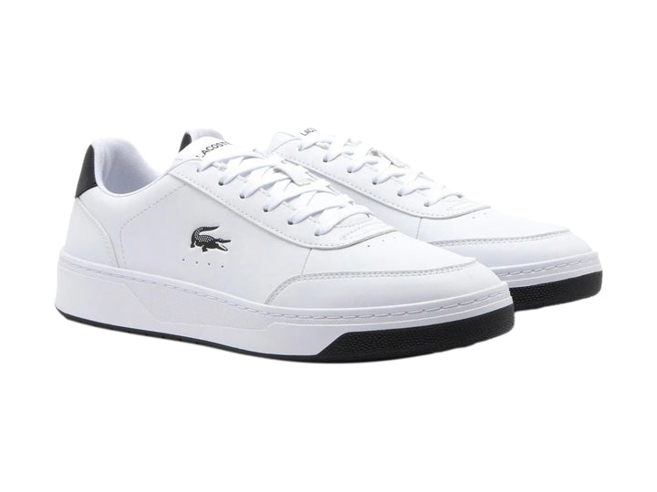 Tenis Lacoste blancos con detalles en negro en el talón y la suela.