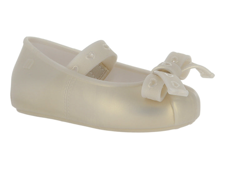 Zapato plano color beige para niña con detalle de moño al frente.