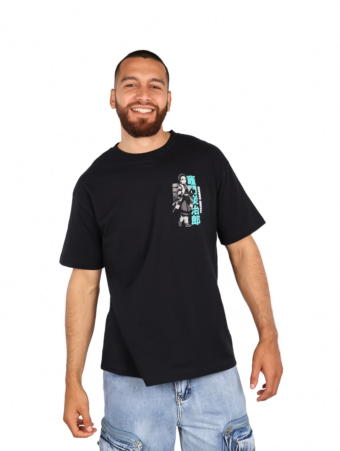 Hombre vistiendo playera negra oversized con estampado de anime Demon Slayer en el pecho.