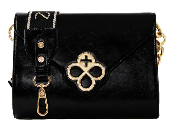 Bolso Jaime Ibiza color negro con detalles dorados, correa textil y cierre de solapa.