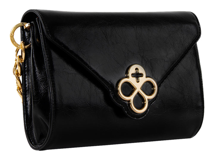 Bolso Jaime Ibiza color negro con detalles dorados, correa textil y cierre de solapa.