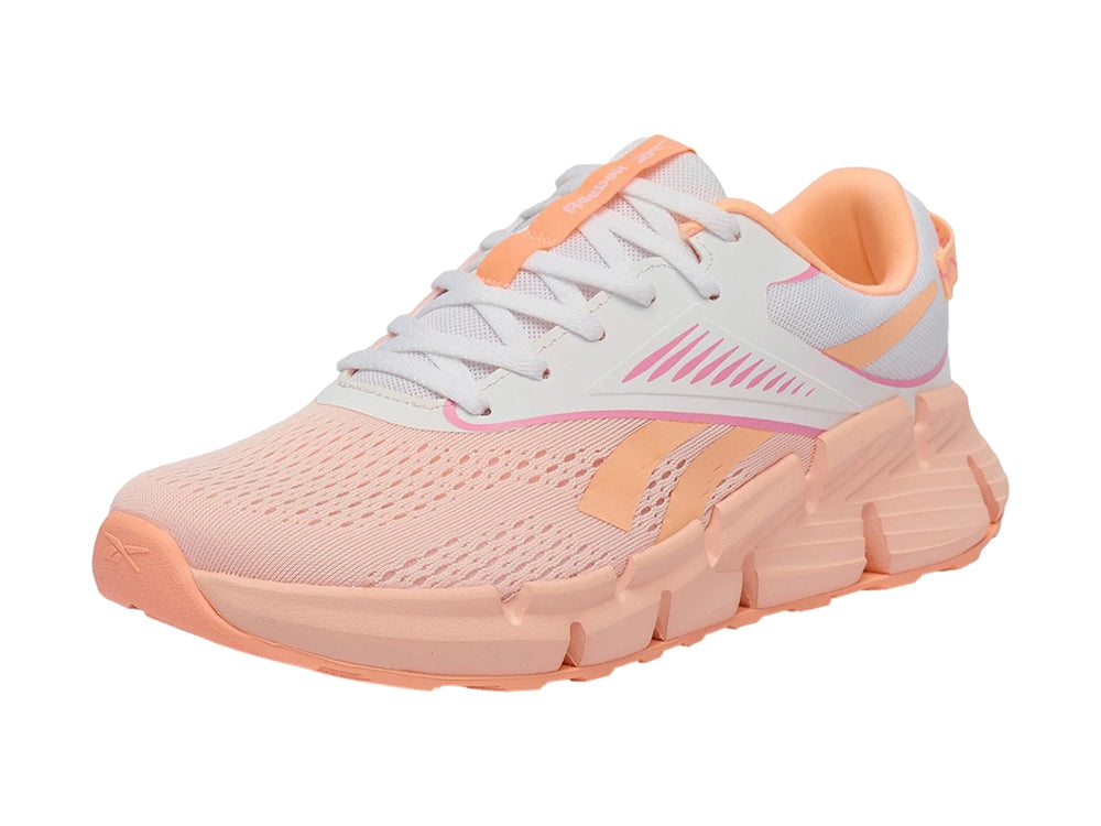 Tenis deportivos Reebok Zig Dynamica en color rosa y blanco con suela gruesa segmentada.