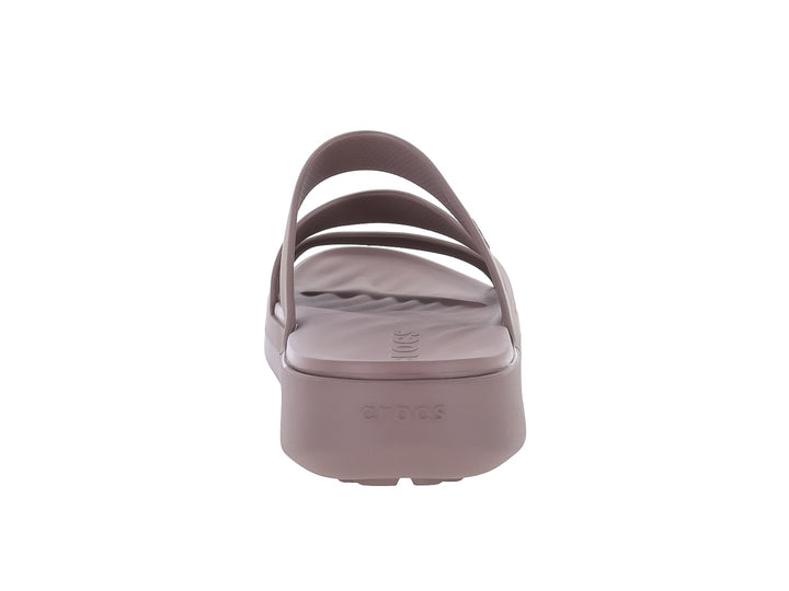 Sandalia Crocs color truffle con tres tiras anchas y suela plana.