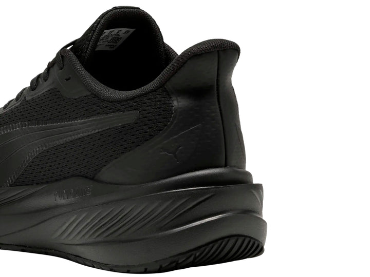Tenis deportivo PUMA Dasher Lite en color negro total, vista lateral.