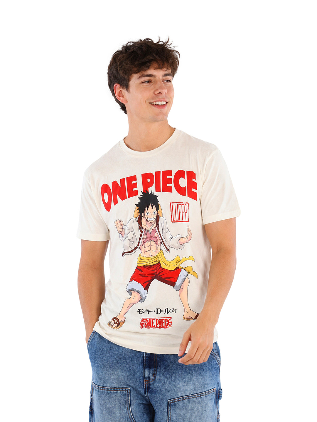 Hombre vistiendo playera color hueso con estampado de One Piece y jeans azules.
