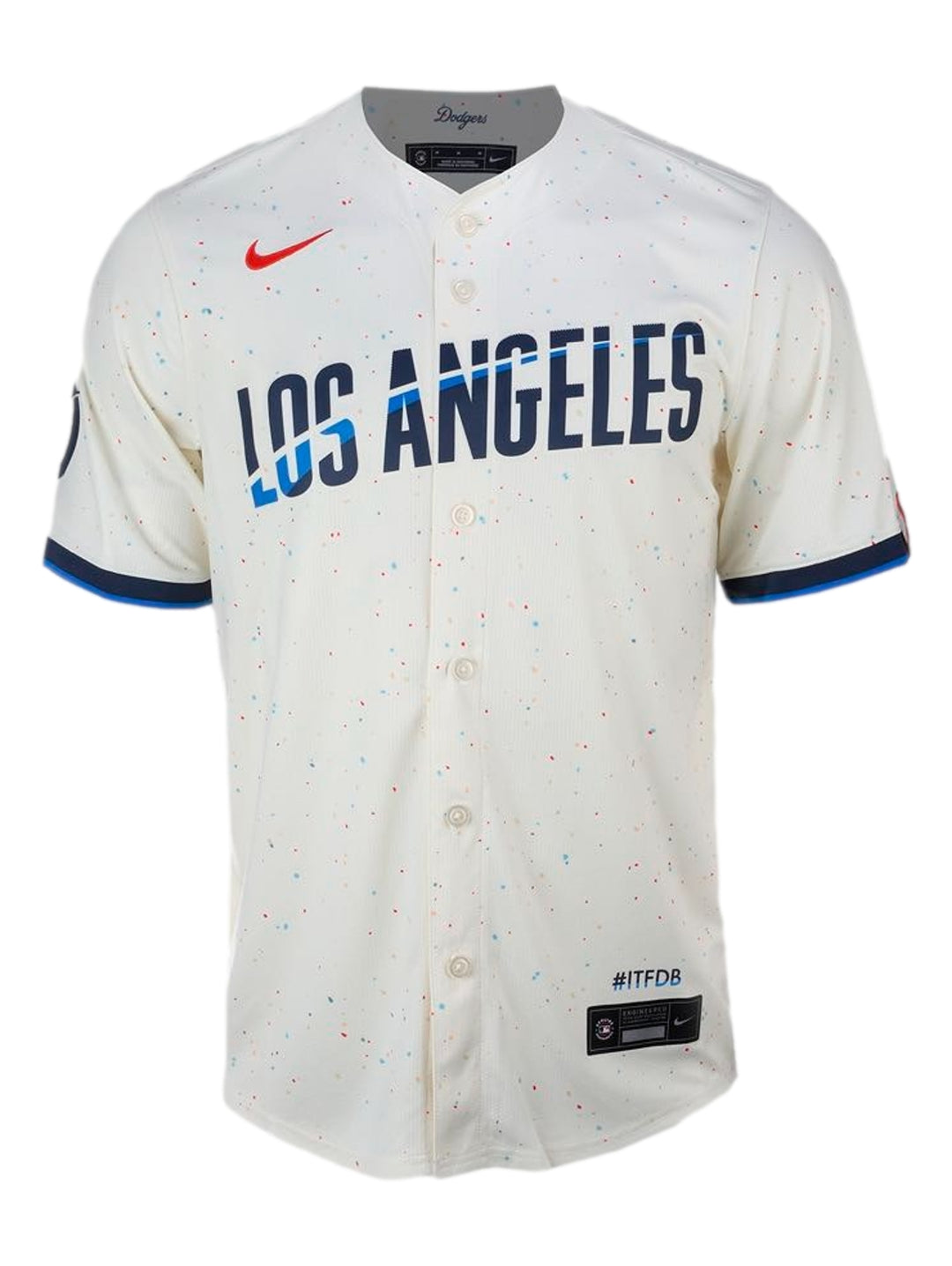 Jersey de béisbol Nike Limited Dodgers City Connect color beige con letras azules y detalles rojos y azules.