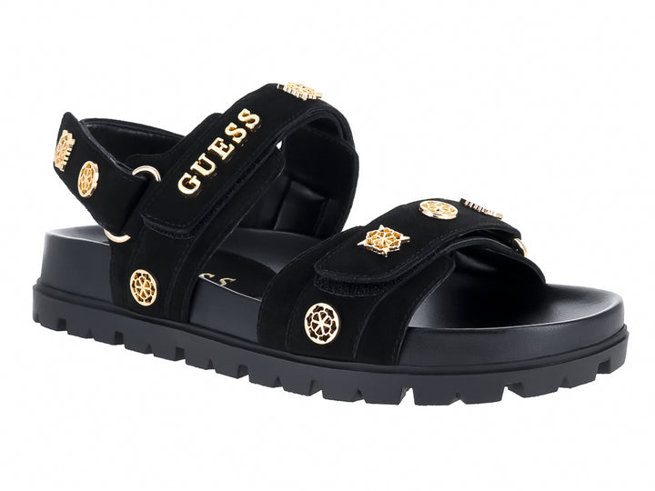 Sandalia negra de plataforma con correas y detalles metálicos dorados de la marca GUESS.