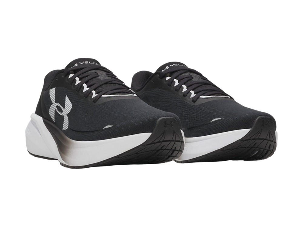 Tenis deportivos Under Armour color negro con suela blanca y logotipo blanco lateral.