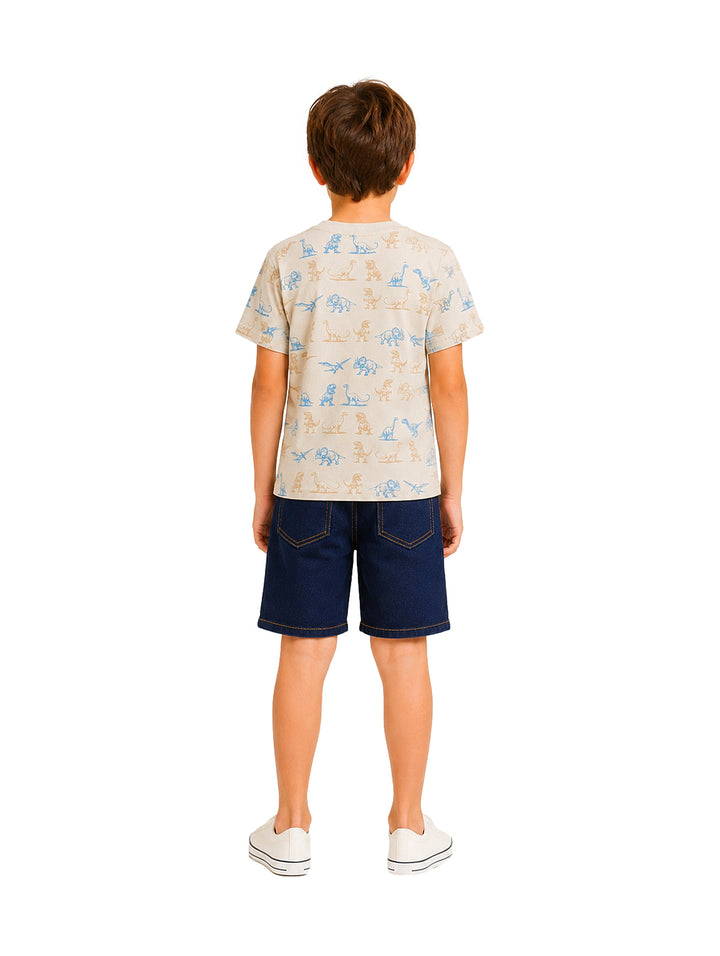 Niño vistiendo un conjunto de camiseta beige con estampados de dinosaurios y shorts azul marino.
