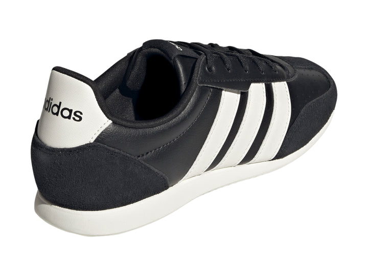 Tenis deportivos Adidas color negro con tres franjas blancas laterales y suela blanca.