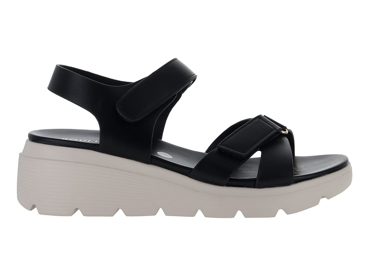 Sandalia negra de plataforma blanca con correas ajustables de velcro para mujer.